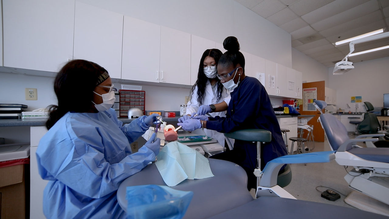 Dental students practicing procedures in clinical classroom